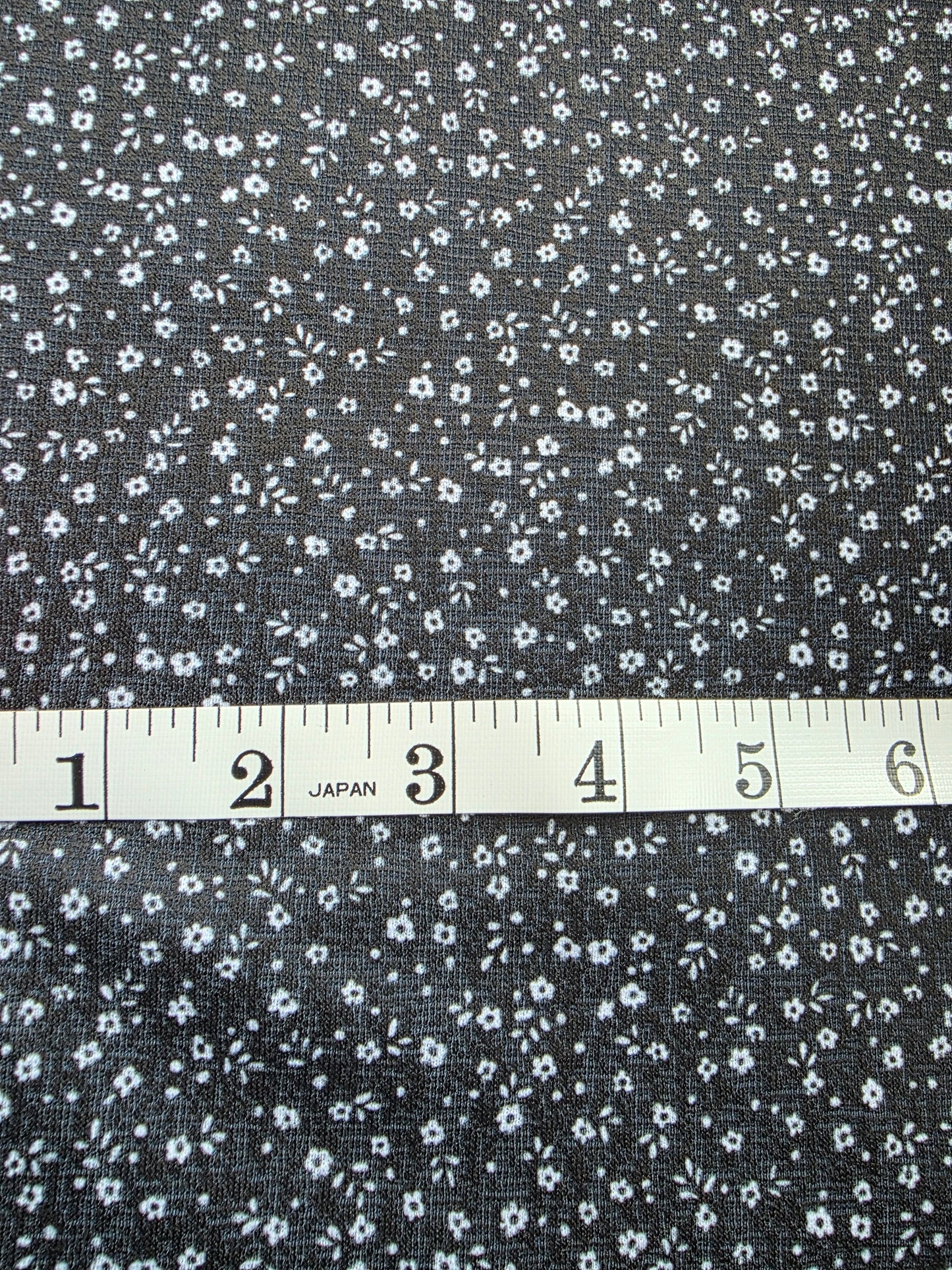 Black Tiny Floral Eggshell Knit | Sold By The Half Yard
